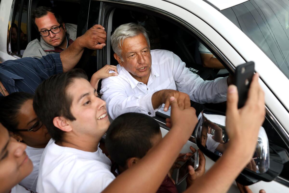 Supporters try to get a photo with Andres Manuel Lopez Obrador after he spoke at a National Regeneration Movement campaign rally.
