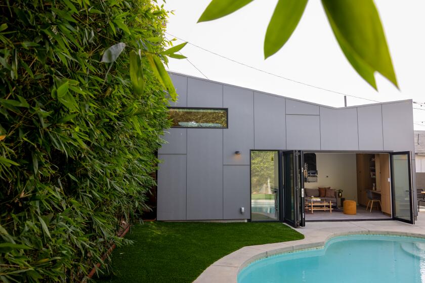 Los Angeles, CA - November 10: Architect Lisa Little of Vertebrae, designed a 380-square-foot ADU in the Larchmont neighborhood of Los Angeles, for actress Leslie-Anne Huff and her husband Reggie Panaligan and is photographed, Friday, Nov. 10, 2023. The footprint of the building is asymmetric (trapezoidal) and the roof is asymmetric both in plan and elevation, keeping it from looking like a traditional "box." The studio is an example of how to reimagine a neglected carport as smart, multigenerational housing. The ADU is used for grandparents to come on extended stays, since the couple has a young child. It is also a full-time work-from-home office, guest house, and extension of the family living space by integrating the pool and yard into the larger programmatic space of the home and site. (Jay L. Clendenin / Los Angeles Times)
