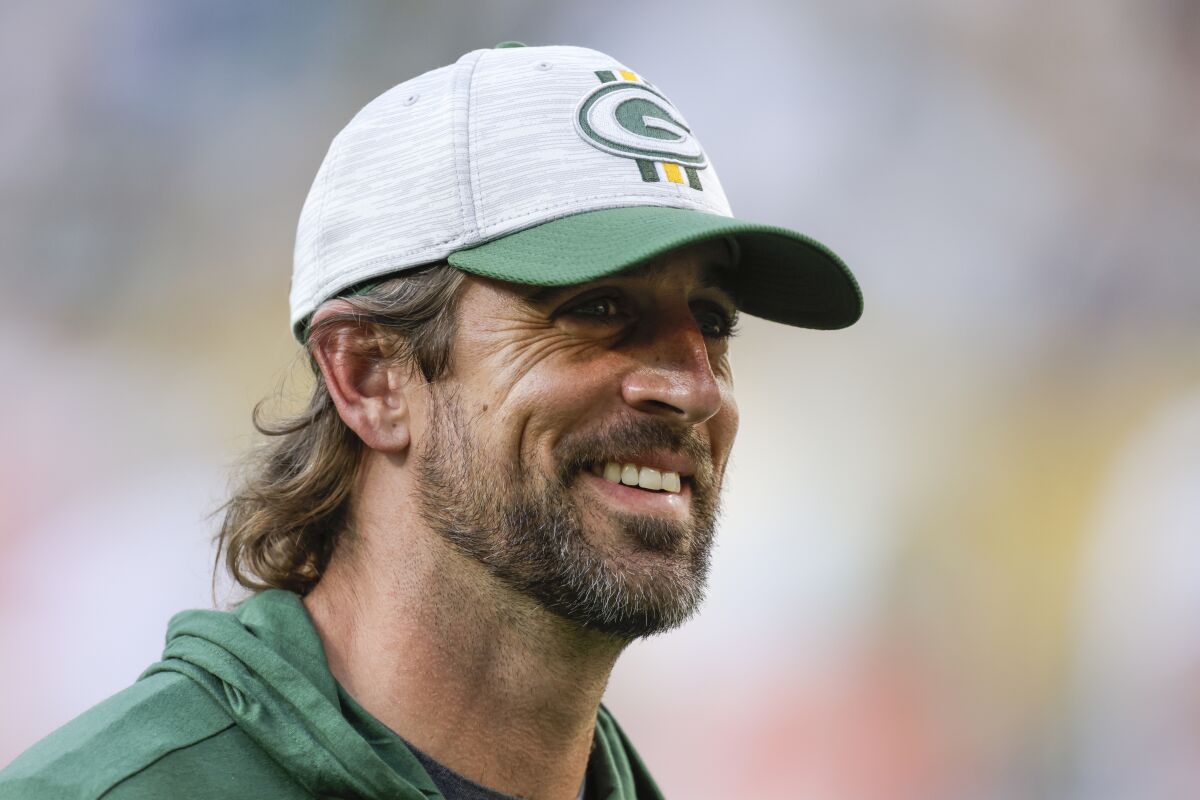 Green Bay Packers' Aaron Rodgers smiles after a preseason NFL football game against the New York Jets Saturday, Aug. 21, 2021, in Green Bay, Wis. The Jets won 23-14. (AP Photo/Matt Ludtke)