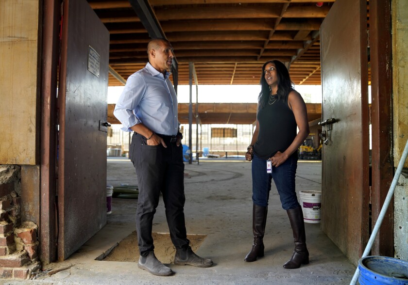 Two people standing in the doorway of a building under construction