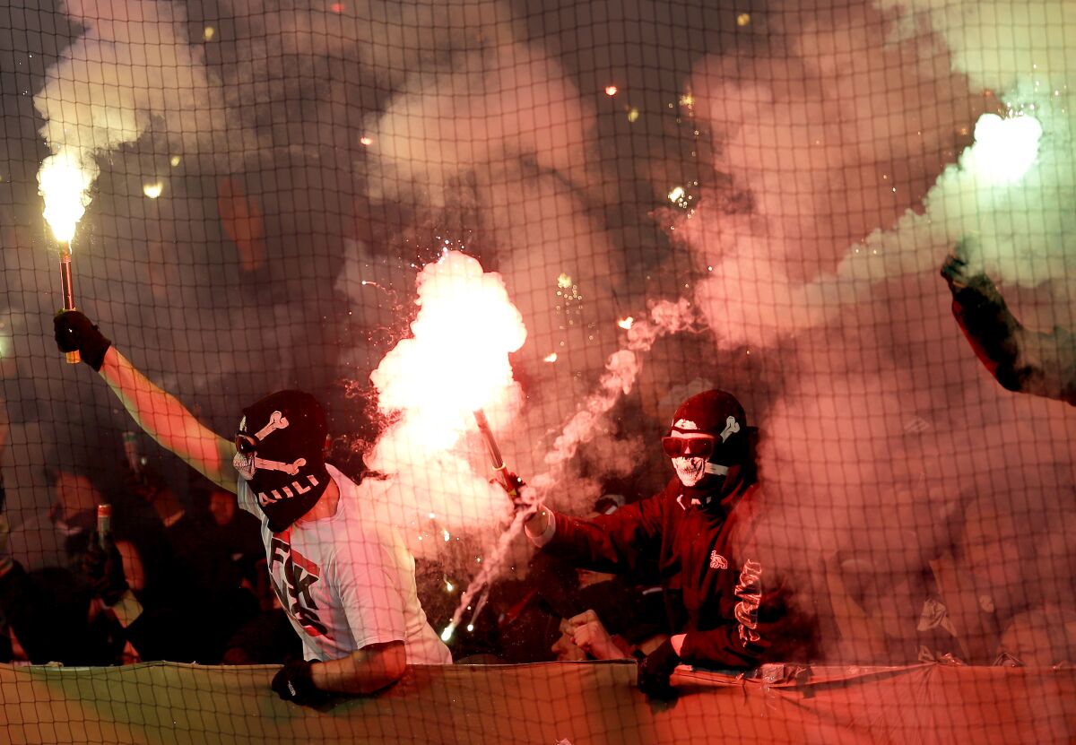 FILE - In this file photo dated Tuesday, Oct. 28, 2014, supporters of St. Pauli light fireworks during the German soccer cup second round match between FC St. Pauli and Borussia Dortmund at the Millerntor Stadium in Hamburg, Germany. (AP Photo/Michael Sohn, FILE)