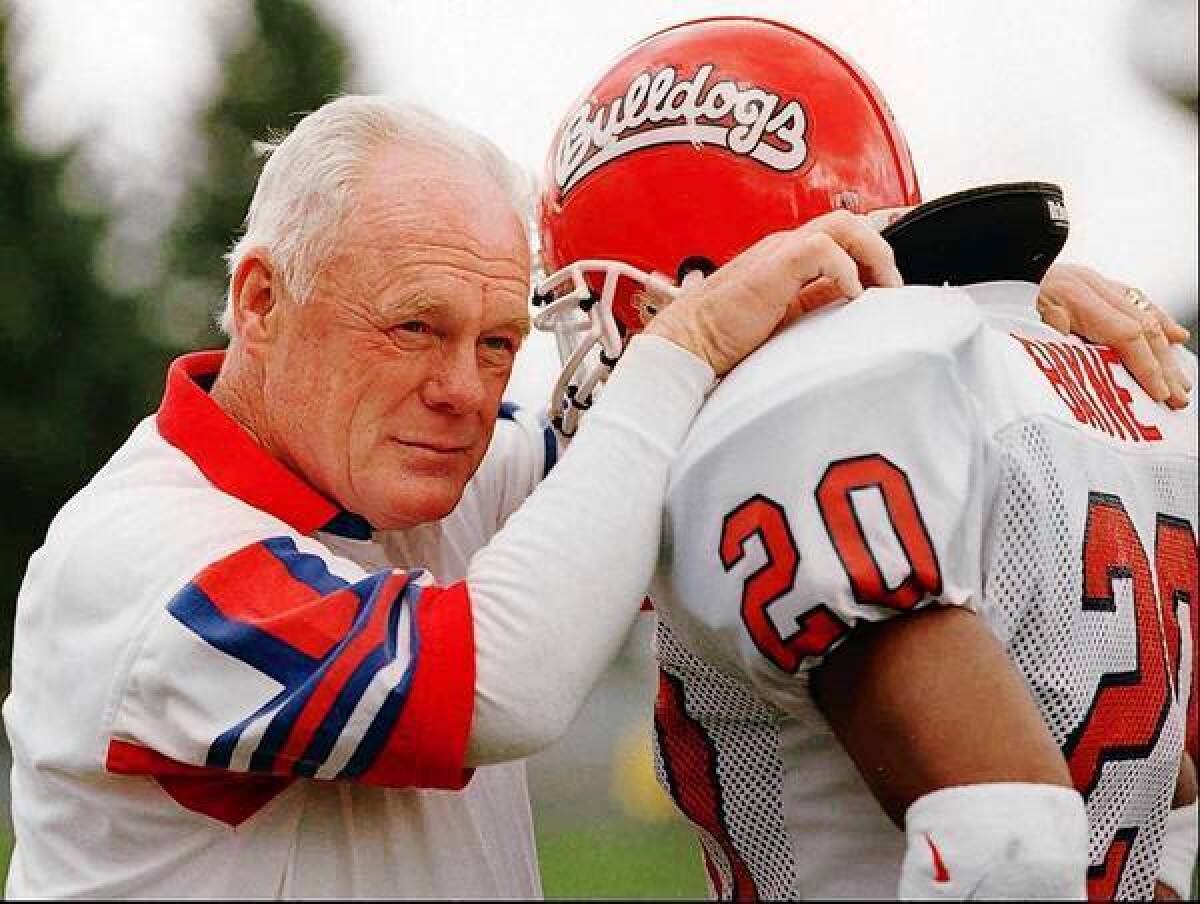 Fresno State footballl coach Jim Sweeney, left, talks to Chris Bayne during a 1996 game against Wyoming State.