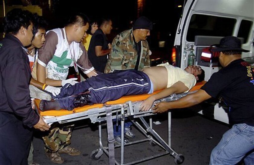 An injured anti-government protester is wheeled to an ambulance after a bomb attack at their protesting ground of government house in Bangkok, Thailand Saturday, Nov. 22, 2008. A grenade attack on protesters occupying the Thai prime minister's office wounded eight people early Saturday, officials said. (AP Photo)