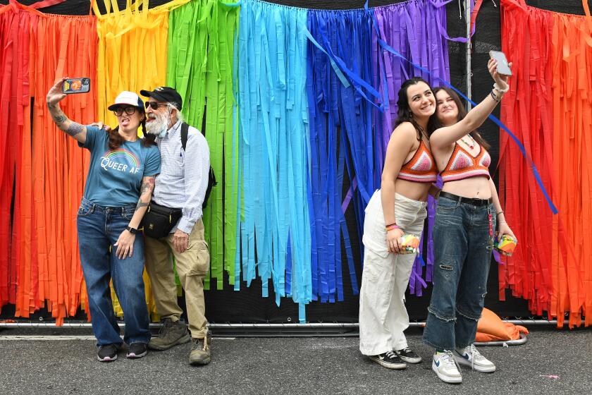 Hollywood, California June 11, 2023-People take selfies along Hollywood Blvd. during the Gay Pride Parade Sunday. (Wally Skalij/Los Angeles Times)