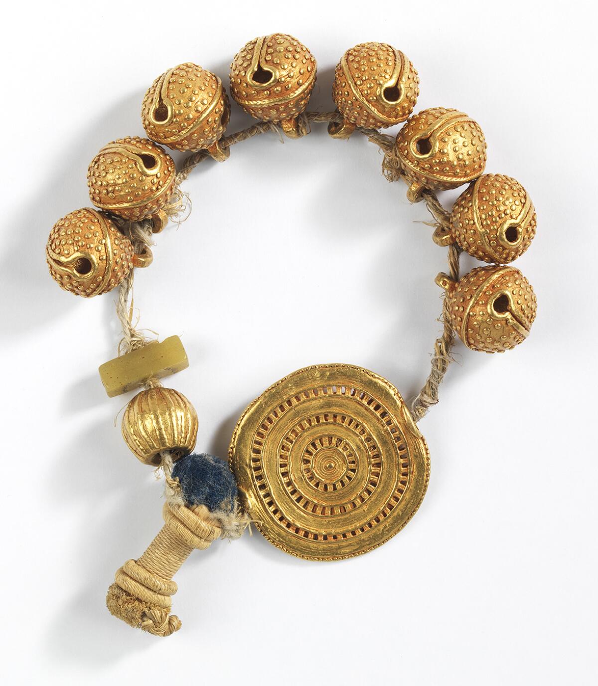 A beaded gold bracelet or anklet.