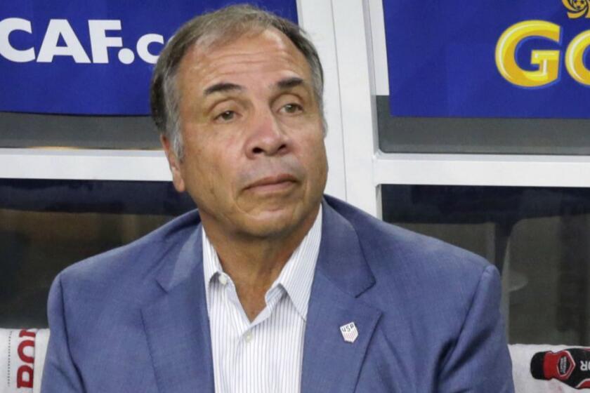 FILE - In this July 22, 2017, file photo, United States head coach Bruce Arena sits on the bench prior to a CONCACAF Gold Cup semifinal soccer match against Costa Rica, in Arlington, Texas. The New England Revolution have hired five-time MLS Cup winner and former U.S. national coach Bruce Arena as its coach and sports director. (AP Photo/LM Otero, File)