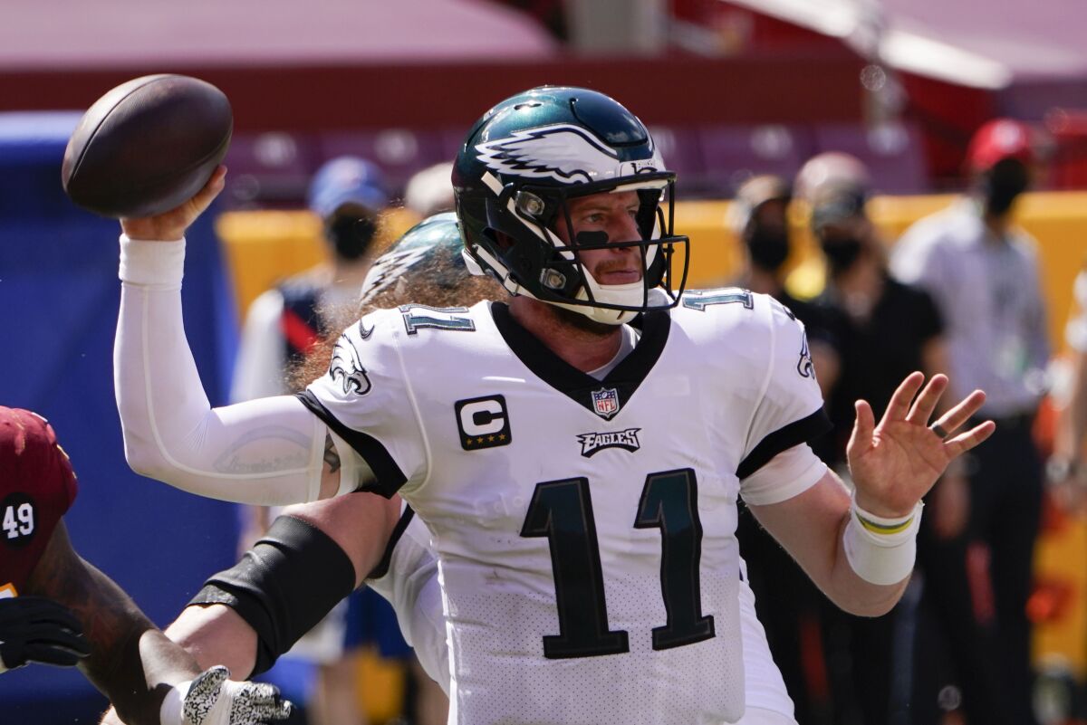 Philadelphia Eagles quarterback Carson Wentz looks to pass the ball against the Washington Football Team during the first half of an NFL football game, Sunday, Sept. 13, 2020, in Landover, Md. (AP Photo/Susan Walsh)
