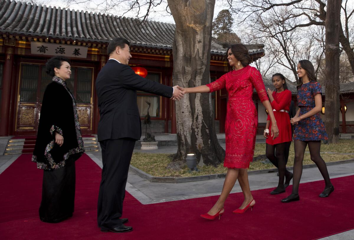 First Lady Michelle Obama, with daughters Malia, right, and Sasha, is greeted by Chinese President Xi Jinping and his wife, Peng Liyuan, at the Diaoyutai State Guesthouse in Beijing.