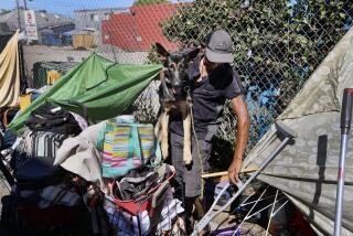 Long Beach, CA - August 20: Miguel Angel Gonzalez Martinez, 42, and his dog Lincoln, who moved his makeshift tent to the Mars Ct. alley, next to 7th St., 1 block away from Gumbinger Park, where he and others left and is now closed in Long Beach. Homeless encampments are beginning to be cleared out in Long Beach Tuesday, Aug. 20, 2024. The city of Long Beach will begin to perform outreach services to homeless encampments at various parks and the Billy Jean King library in downtown as part of its effort to enforce anti-camping ordinances and encourage homeless people to move indoors. Gumbiner Park is among those which has already been fenced. Allen J. Schaben / Los Angeles Times)