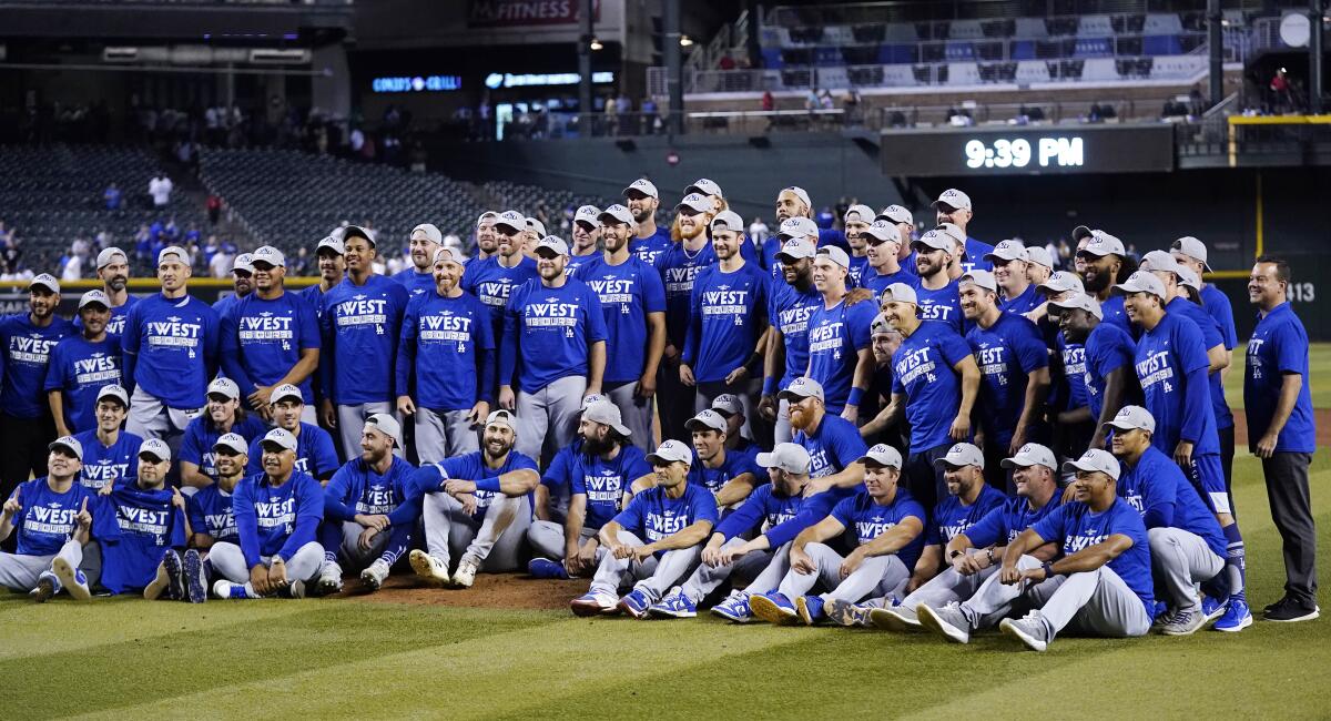 Dodgers players and coaches gather for a team photo after clinching the National League West title.