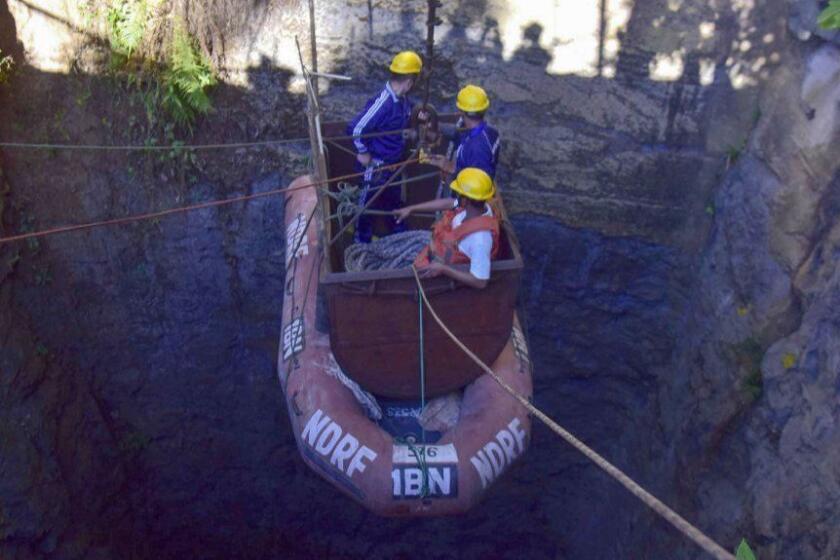 (FILES) In this file photo taken on December 30, 2018 Indian Navy divers are lowered into a mine with a pulley during rescue operations to help 15 miners trapped by flooding in an illegal coal mine in Ksan village in Meghalaya's East Jaintia Hills district. - Two miners have been killed in India's remote northeast, police said January 7, 2019 as rescuers kept up efforts to save 15 workers trapped for over three weeks in an illegal mine. (Photo by STR / AFP)STR/AFP/Getty Images ** OUTS - ELSENT, FPG, CM - OUTS * NM, PH, VA if sourced by CT, LA or MoD **
