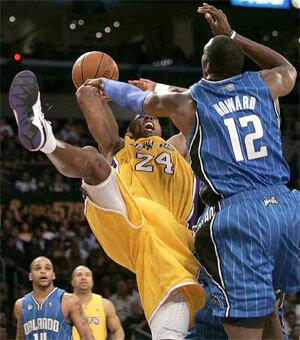 Lakers guard Kobe Bryant can't get a shot past Orlando center Dwight Howard late in the fourth quarter Friday night.