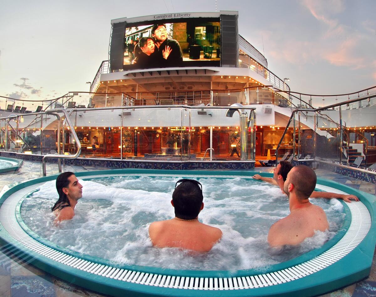 TR.0718.Log24.1-- Guests aboard the Carnival Liberty relax in a whirlpool while enjoying a movie on Carnival's Seaside Theatre screen. The 270-square-foot screen is similar to those featured in large stadiums and includes a 70,000-watt sound system, providing concert-quality sound for all showings. Photo by Andy Newman/CCL