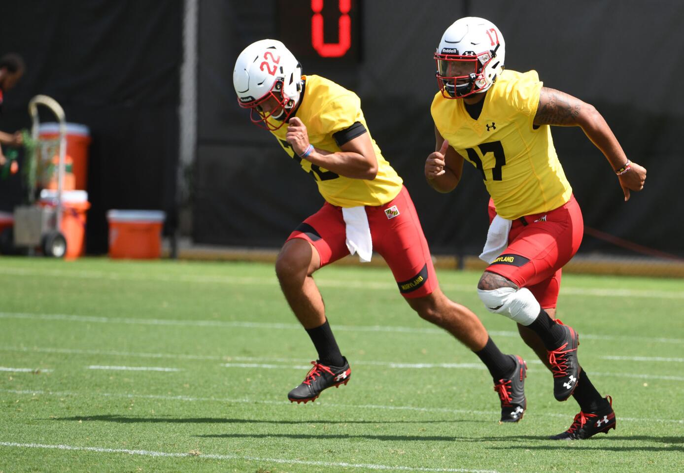 From left, Eric Najarian and Josh Jackson, University of Maryland QBs, sprint to their next drill at the Terps training camp on media day.