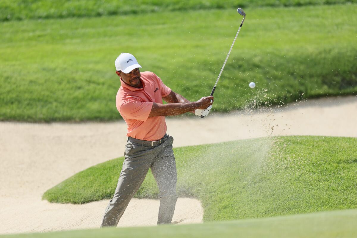 Tiger Woods plays a shot from a bunker on the 17th hole during the first round of the PGA Championship.