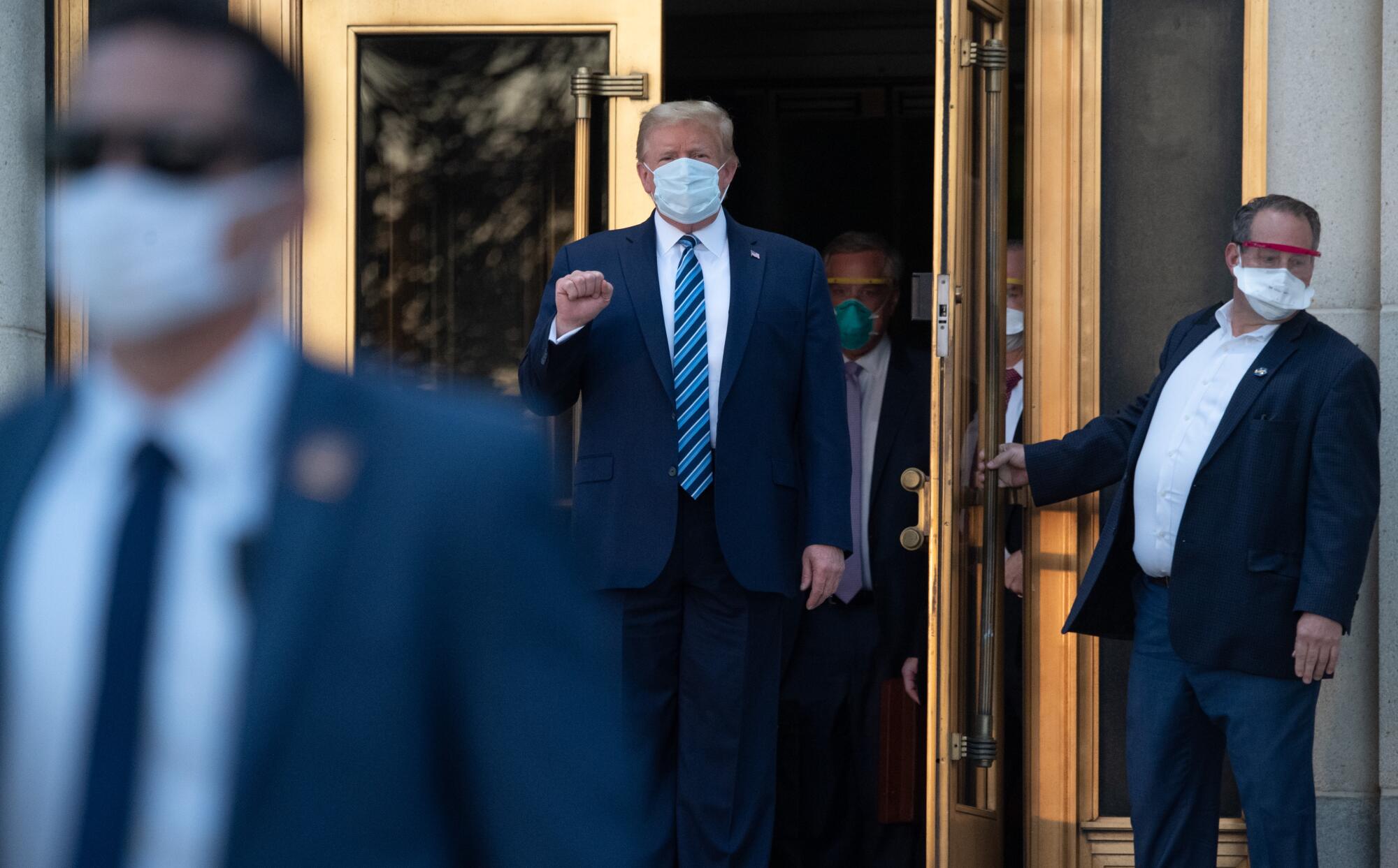 President Trump walks out of Walter Reed hospital in Bethesda, Md.