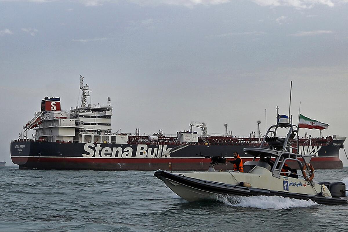 In this July 21 photo, a speedboat of Iran’s Revolutionary Guard moves around British-flagged oil tanker Stena Impero, which was seized by the Guard on July 19 in the Iranian port of Bandar Abbas.
