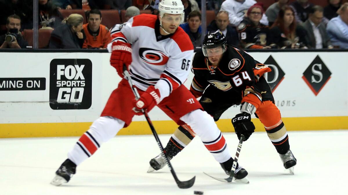 Ducks forward Stefan Noesen tries to poke the puck away from Hurricanes defenseman Ron Hainsey during the first period Wednesday.