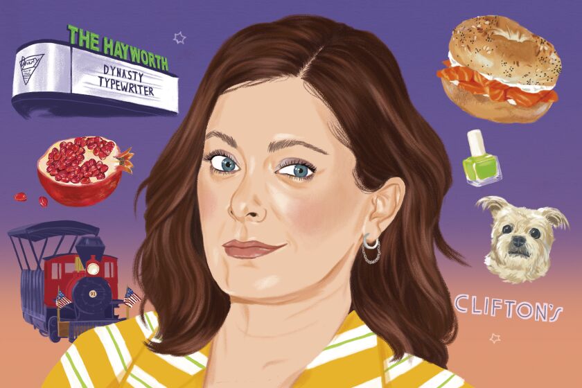 Portrait of Rachel Bloom with Dynasty Typewriter marquee, pomegranate, train, lox bagel, nail polish, dog, and Clifton's logo
