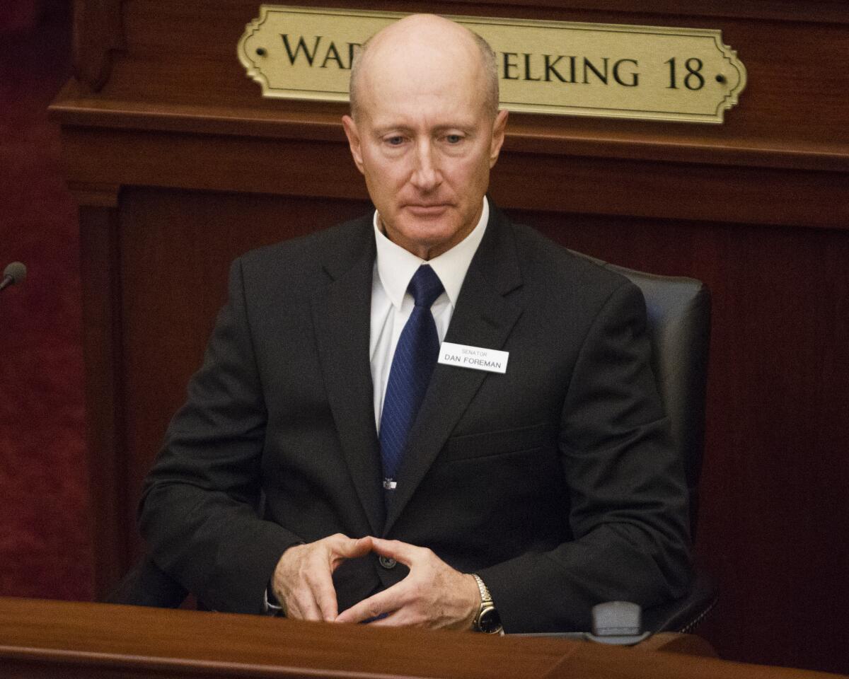 A man sits in a legislative building.