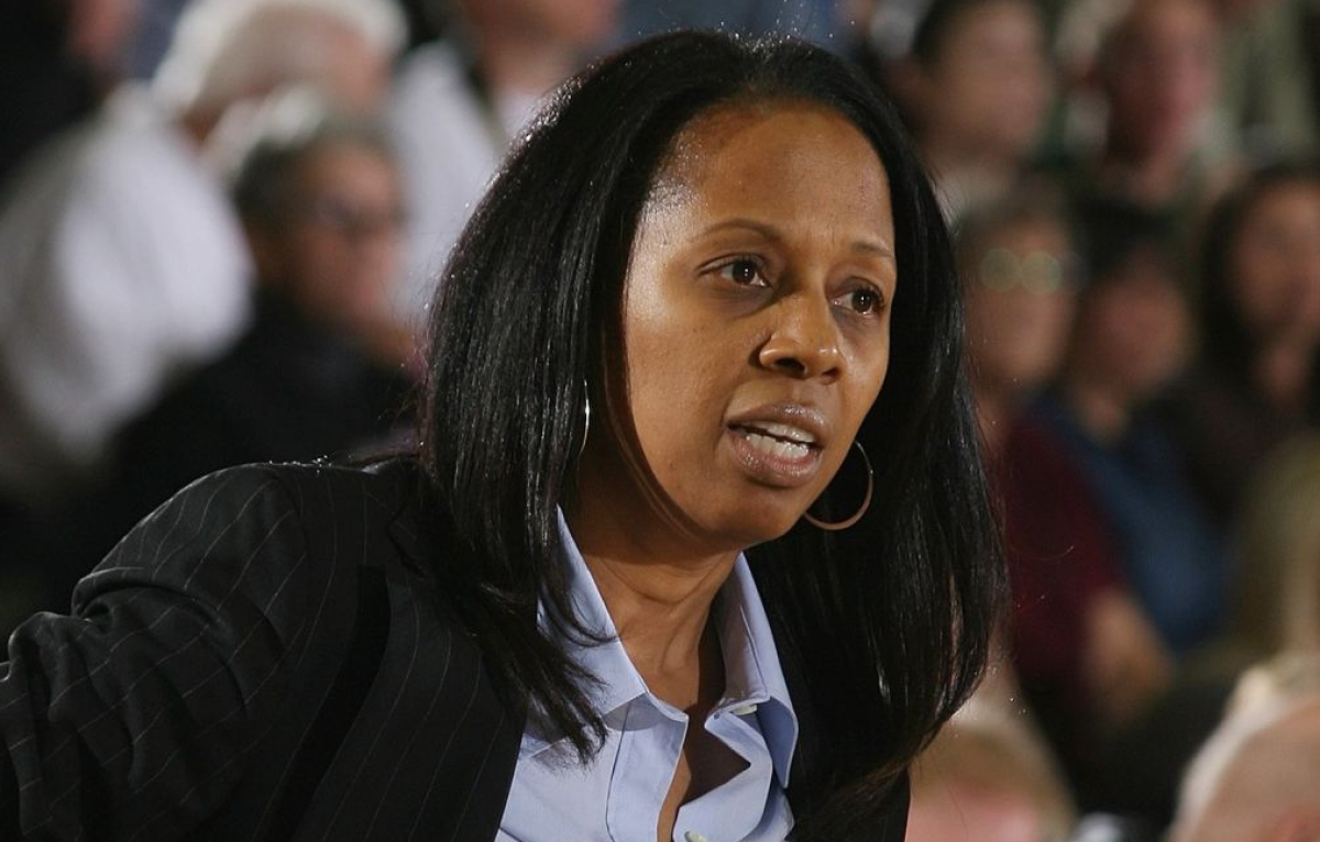 Pepperdine women's basketball coach Julie Rousseau instructs her players during a game.