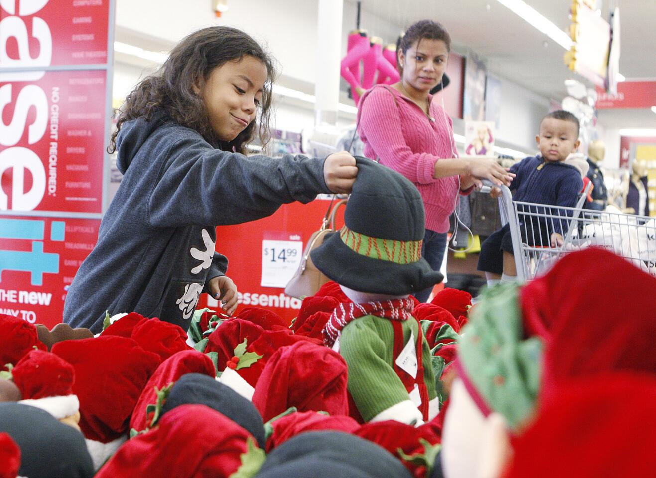 Haley Mejia, 7, of Sun Valley, picks out a doll she wants at the entryway to Kmart in Burbank on Thanksgiving Day on Thursday, November 28, 2013. Kmart, which opened at 6:00 A.M., will be open all day to kick off the Christmas buying frenzy. (Tim Berger/Staff Photographer)