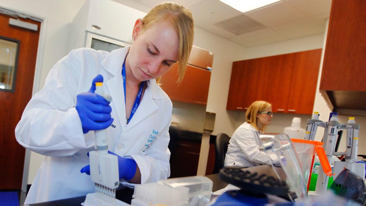 Luca Van Der Kraan prepares patients' DNA samples for sequencing at the Rady Children’s Institute of Genomic Medicine. (K.C. Alfred / Union-Tribune)