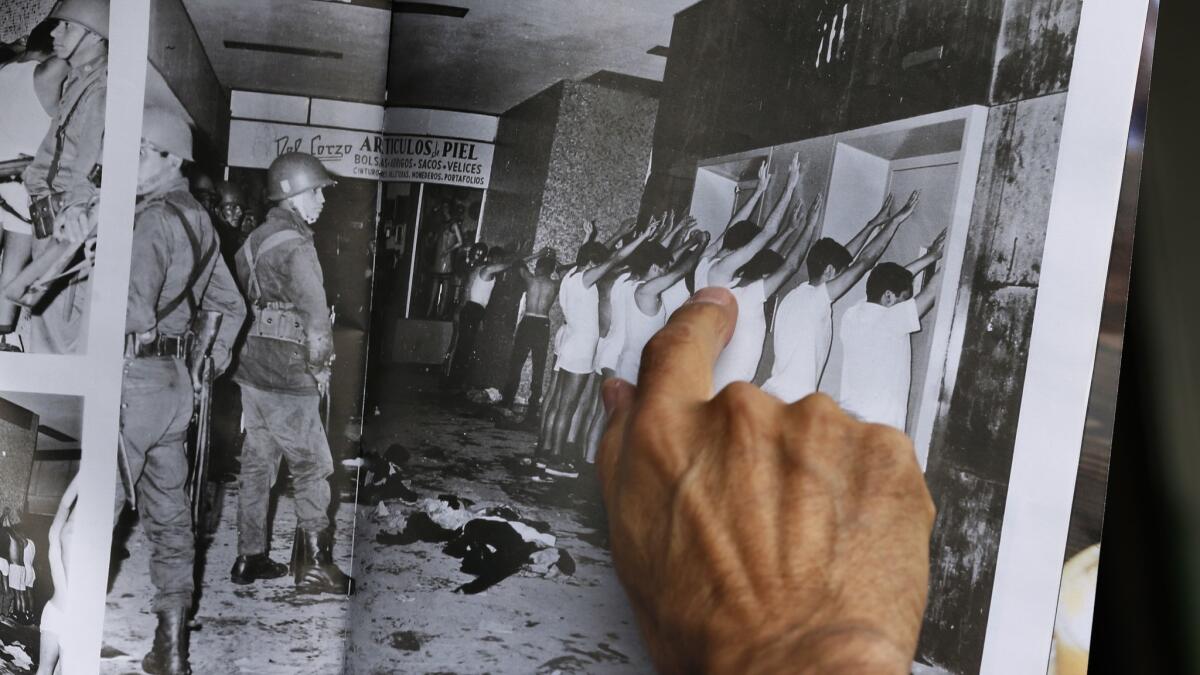 Enrique Espinosa points to himself in a photo where he and other demonstrators are detained after being stripped to their underwear by armed soldiers during the Tlatelolco massacre.