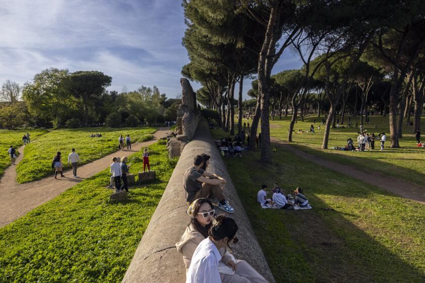 People gather, talk and picnic in the Park of the Aqueducts, 20 minutes by metro from central Rome.