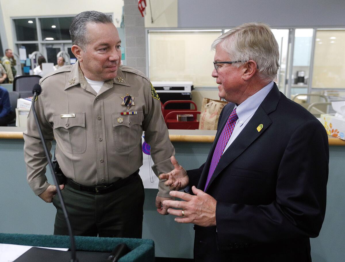 Los Angeles County Sheriff Alex Villanueva and La Canada Flintridge Mayor Len Pieroni talk for a moment at the conclusion of a town hall meeting with the sheriff at La Canada High School on Wednesday, October 23, 2019.