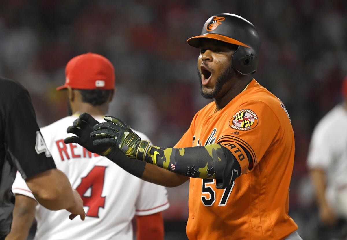 Baltimore Orioles' Hanser Alberto, right, celebrates after hitting a two RBI single as Los Angeles Angels second baseman Luis Rengifo walks away during the eighth inning of a baseball game Saturday, July 27, 2019, in Anaheim, Calif. (AP Photo/Mark J. Terrill)