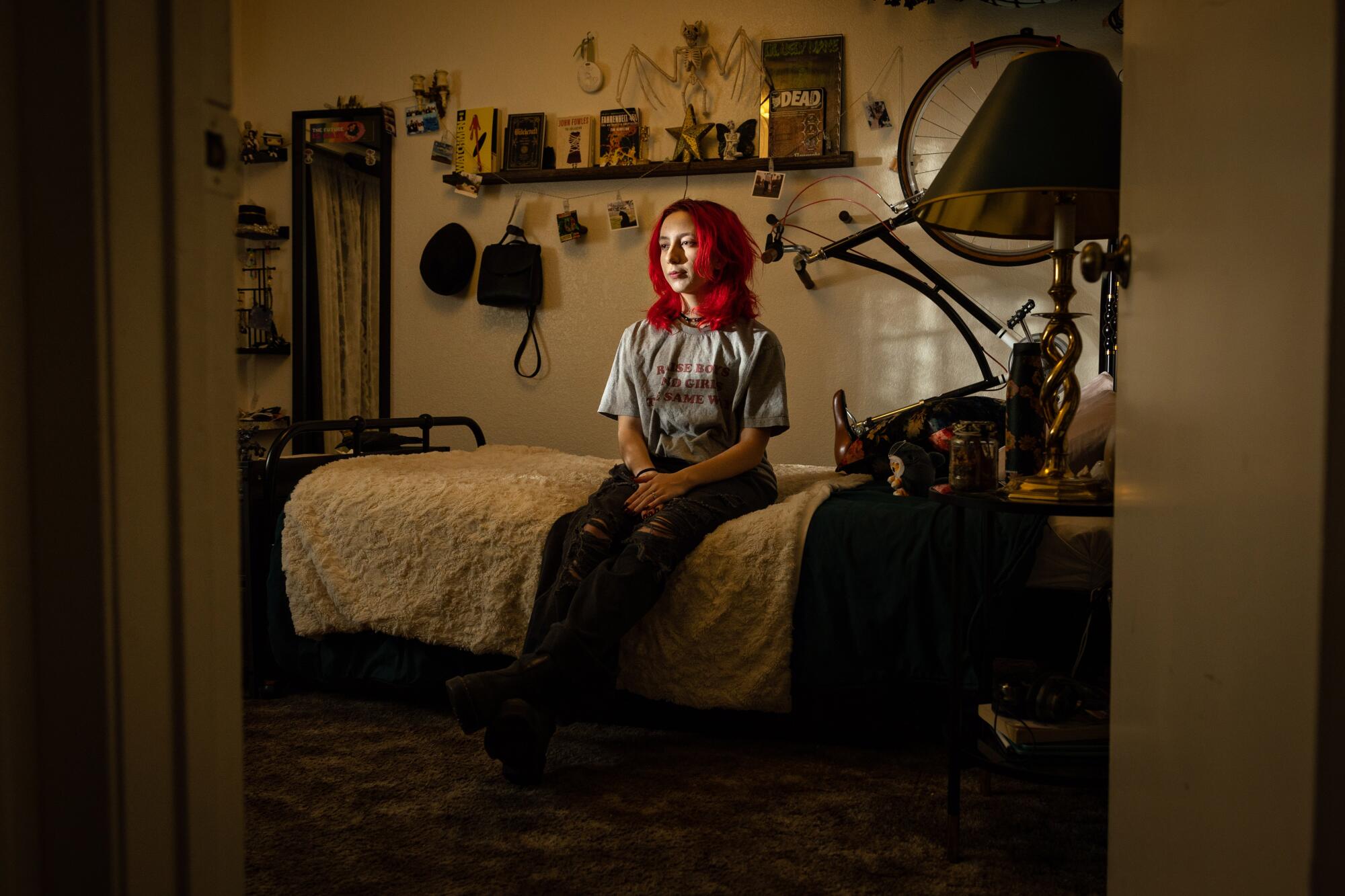 Milo Easley, a 16-year-old trans high school student, poses for a portrait in his bedroom