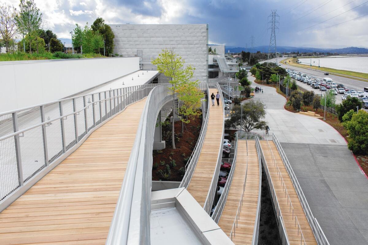 A pedestrian ramp snakes along the north side of Facebook's new Frank Gehry-designed building in Menlo Park, Calif., leading to the rooftop garden.
