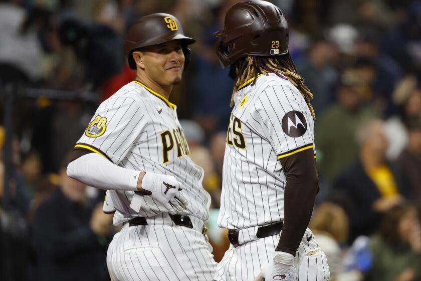 The Padres need more of this kind of celebration from Manny Machado, left, and Fernando Tatis Jr.