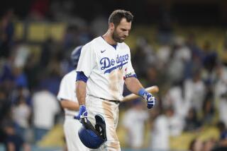 Los Angeles Dodgers' Chris Taylor walks off the field after the team's loss.