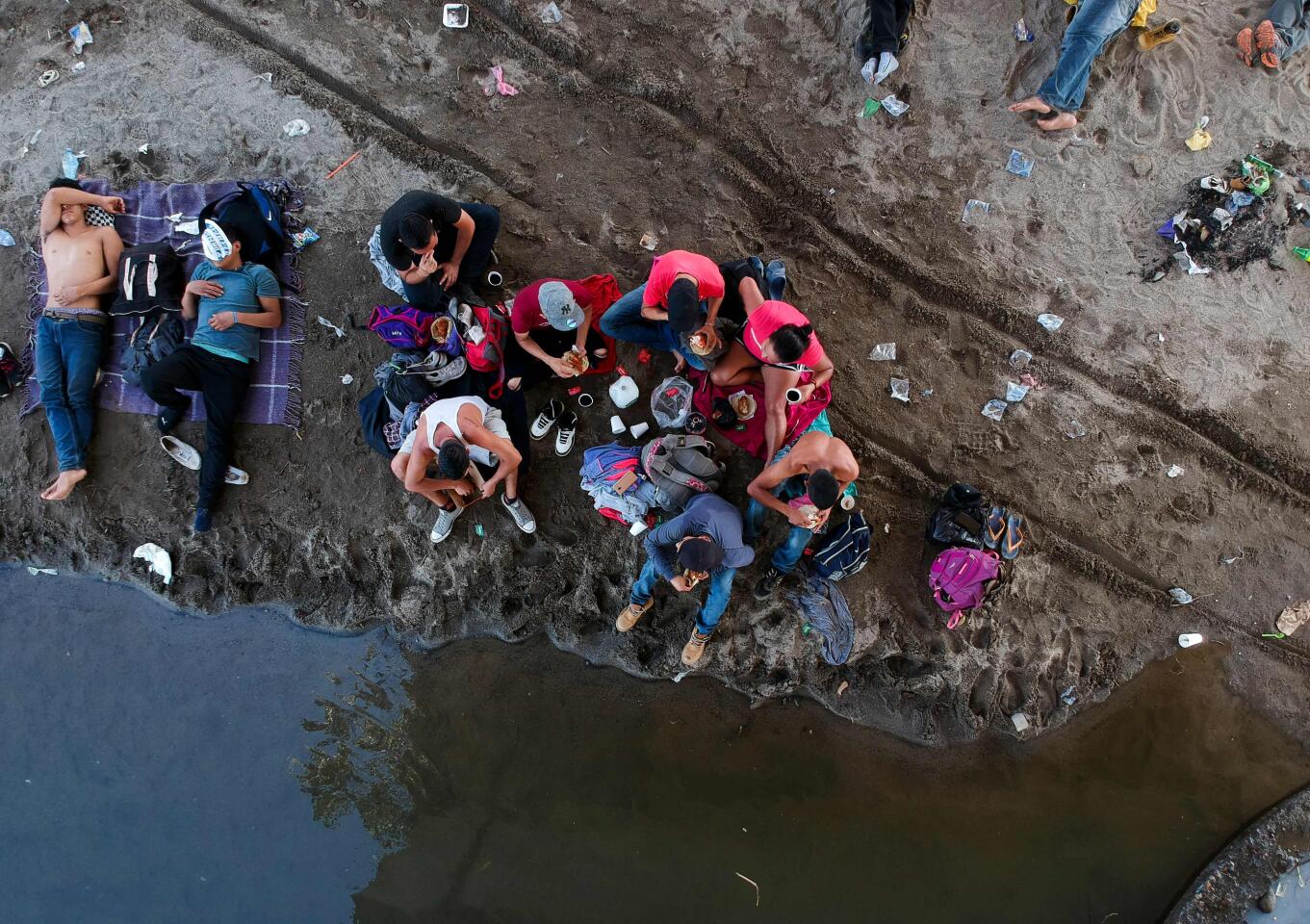 Honduran migrants rest on the banks of the Suchiate River, the natural border between Tecun Uman, Guatemala, and Ciudad Hidalgo, Mexico.