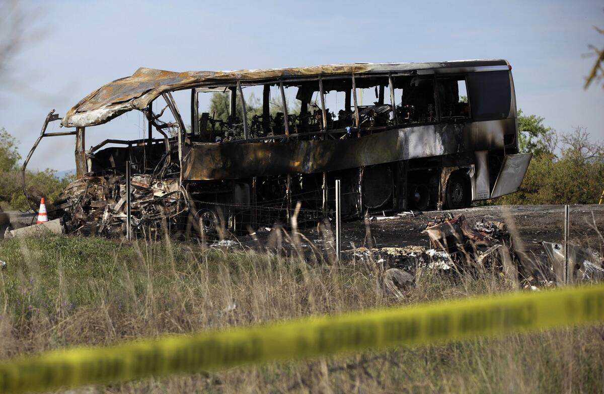 The burned remains of a bus that crashed into a FedEx truck on Interstate 5, near the town of Orland.