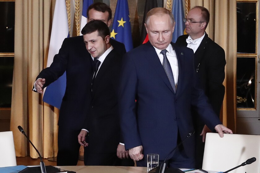 FILE - Russian President Vladimir Putin, right, and Ukrainian President Volodymyr Zelenskyy arrive for a working session at the Elysee Palace, Dec. 9, 2019, in Paris. (Ian Langsdon/Pool via AP, File)