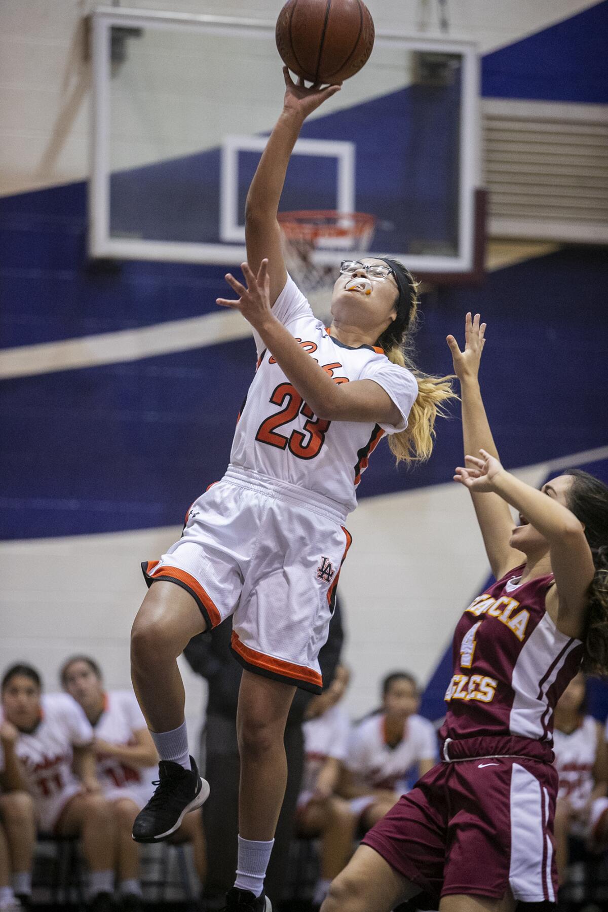 Los Amigos's Rachel Luciano, pictured taking shot in a Dec. 4 game against Estancia, helped the Lobos beat Santa Ana Valley 38-25 in the Hawk Holiday Classic on Thursday.