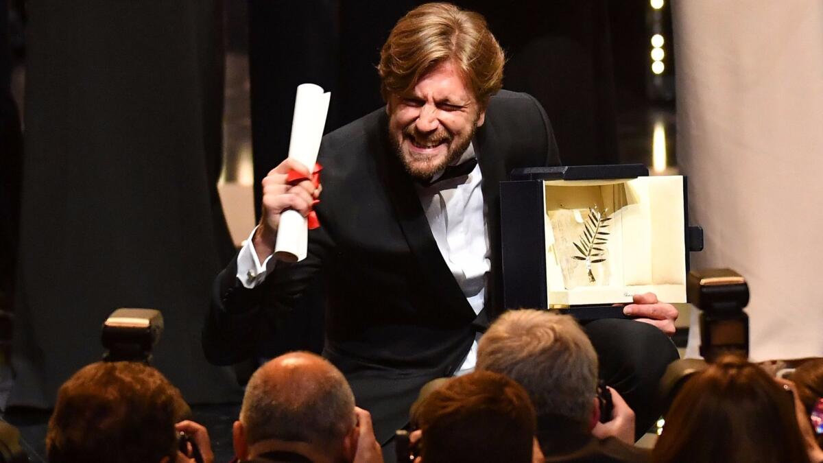 Swedish director Ruben Östlund poses on stage after he was awarded the Palme d'Or for the film 'The Square' at the Cannes Film Festival.