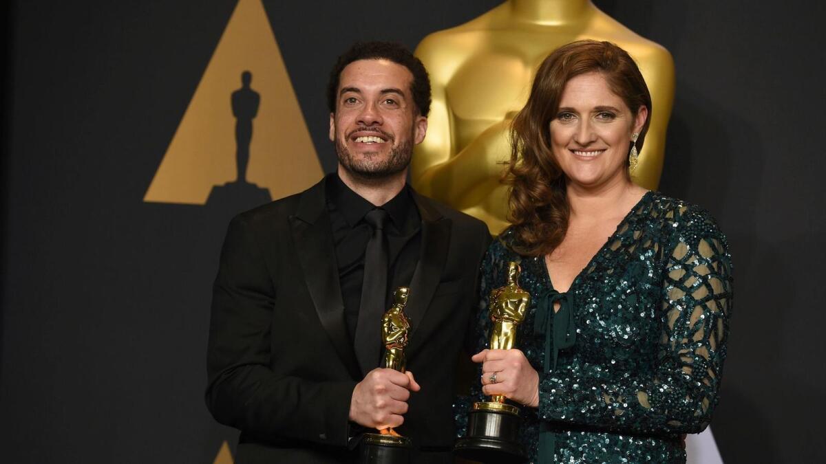 "O.J.: Made in America" director Ezra Edelman, left, and producer Caroline Waterlow after winning the documentary feature award at the Oscars in February.