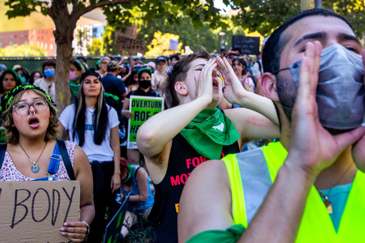 Protesters listen to a speaker during an abortion rights rally