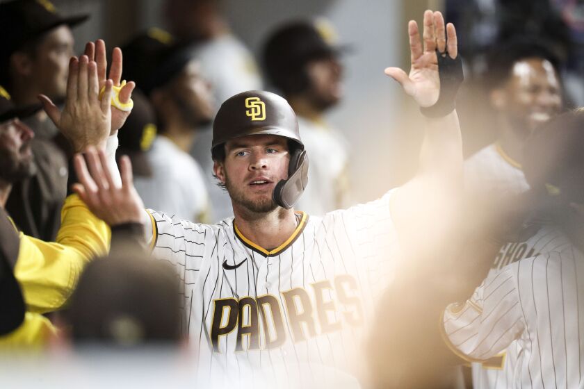 San Diego, CA - October 04: Padres right fielder Wil Myers (5) and teammates celebrate his home run in the dugout during the eighth inning of their game against the Giants at Petco Park on Tuesday, Oct. 4, 2022 in San Diego, CA. (Meg McLaughlin / The San Diego Union-Tribune)