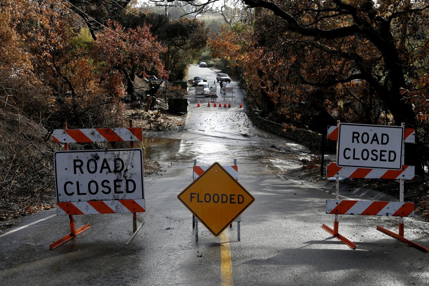 Storm rolls across fire-scarred regions of California