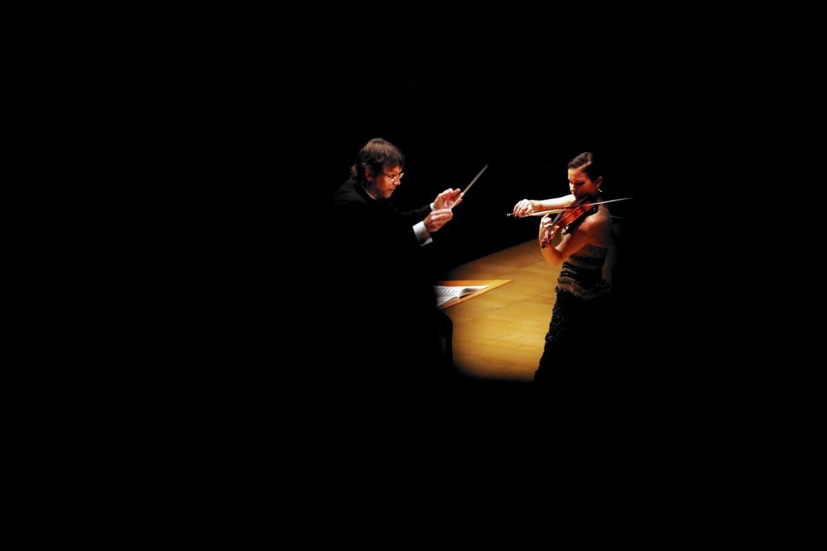 Conductor Andrey Boreyko directs violinist Hilary Hahn and the L.A. Philharmonic in Nielsen's Violin Concerto on Jan. 31, 2014, in Los Angeles.