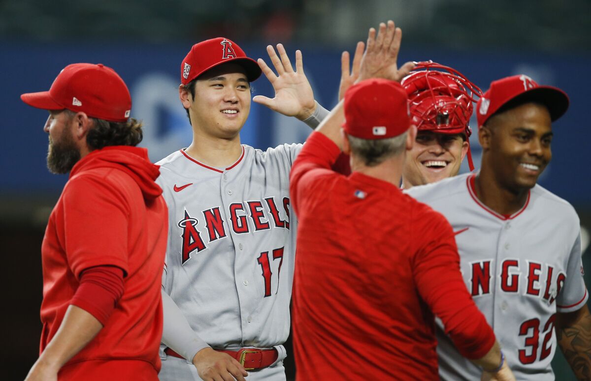Angels designated hitter Shohei Ohtani and his teammates celebrate.