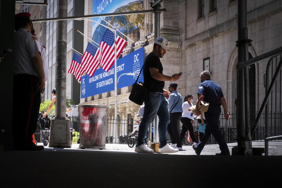 Pedestrians walk past the New York Stock Exchange, Thursday, July 7, 2022 in New York. Stocks rallied again on Wall Street Thursday, and the S&P 500 is closing out a fourth straight gain. (AP Photo/J. David Ake)