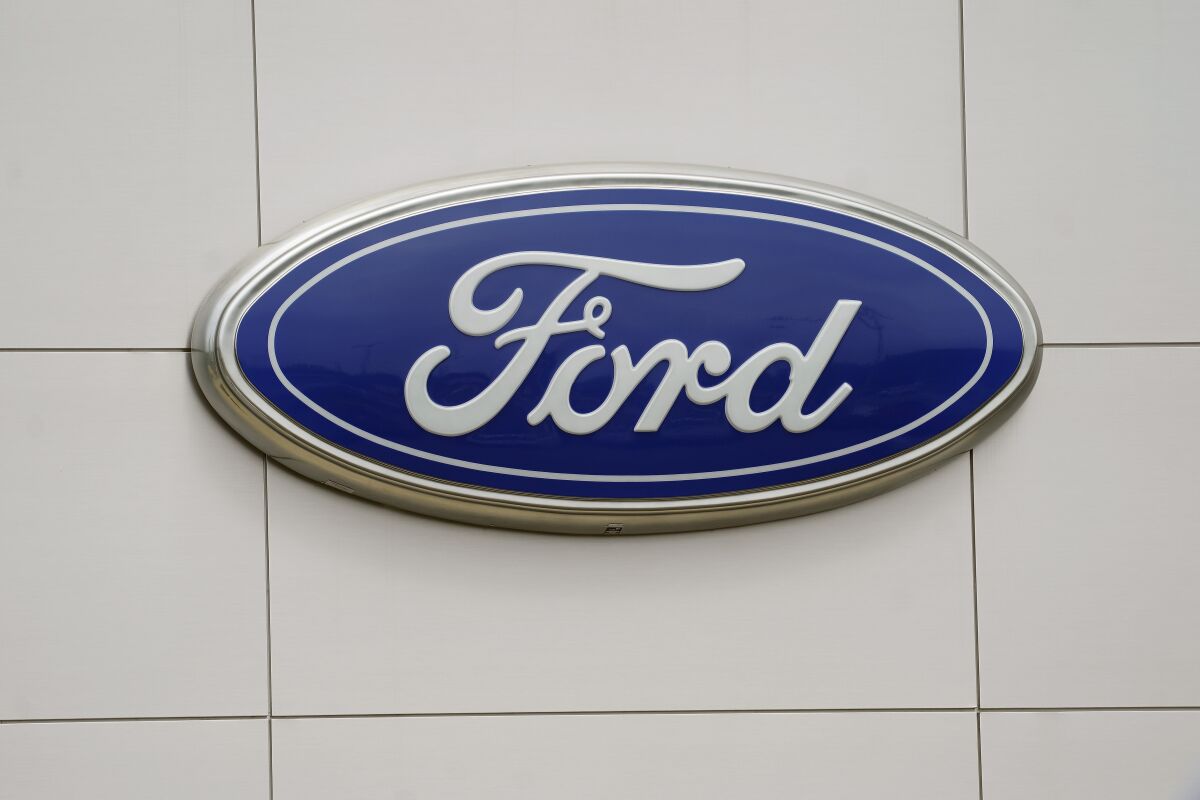 FILE - In this July 27, 2021 file photo, a view of a Ford logo on signage at Country Ford in Graham, N.C. Ford says it will have three new electric passenger vehicles and four new electric commercial vehicles in Europe by 2024, part of the automaker’s continued push to grow its presence in the EV market. Ford Motor Co. said Monday, March 14, 2022 that it plans to sell more than 600,000 electric vehicles in the Europe by 2026. It anticipates producing 1.2 million electric vehicles in Cologne, Germany over six years. (AP Photo/Gerry Broome, File)