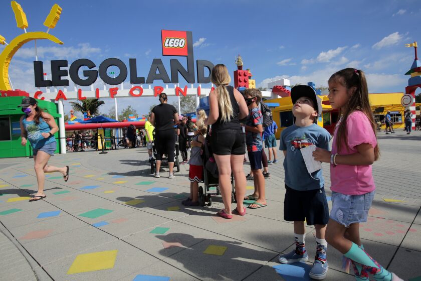 Cutomers wait for entry in front of Legoland in Carlsbad during the reopening of the park Thursday. photo by Bill Wechter