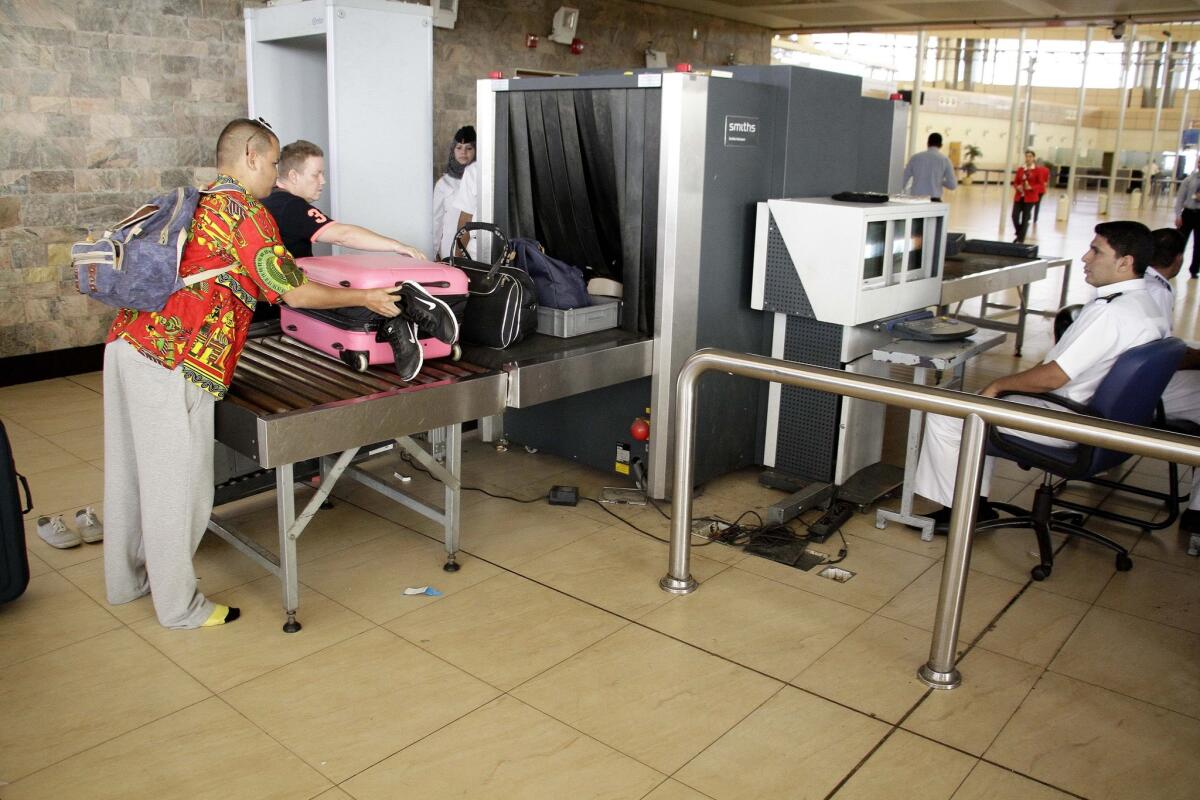 Egyptian security officials screen luggage as passengers prepare to check in at the airport at Sharm el Sheik on Nov. 9.